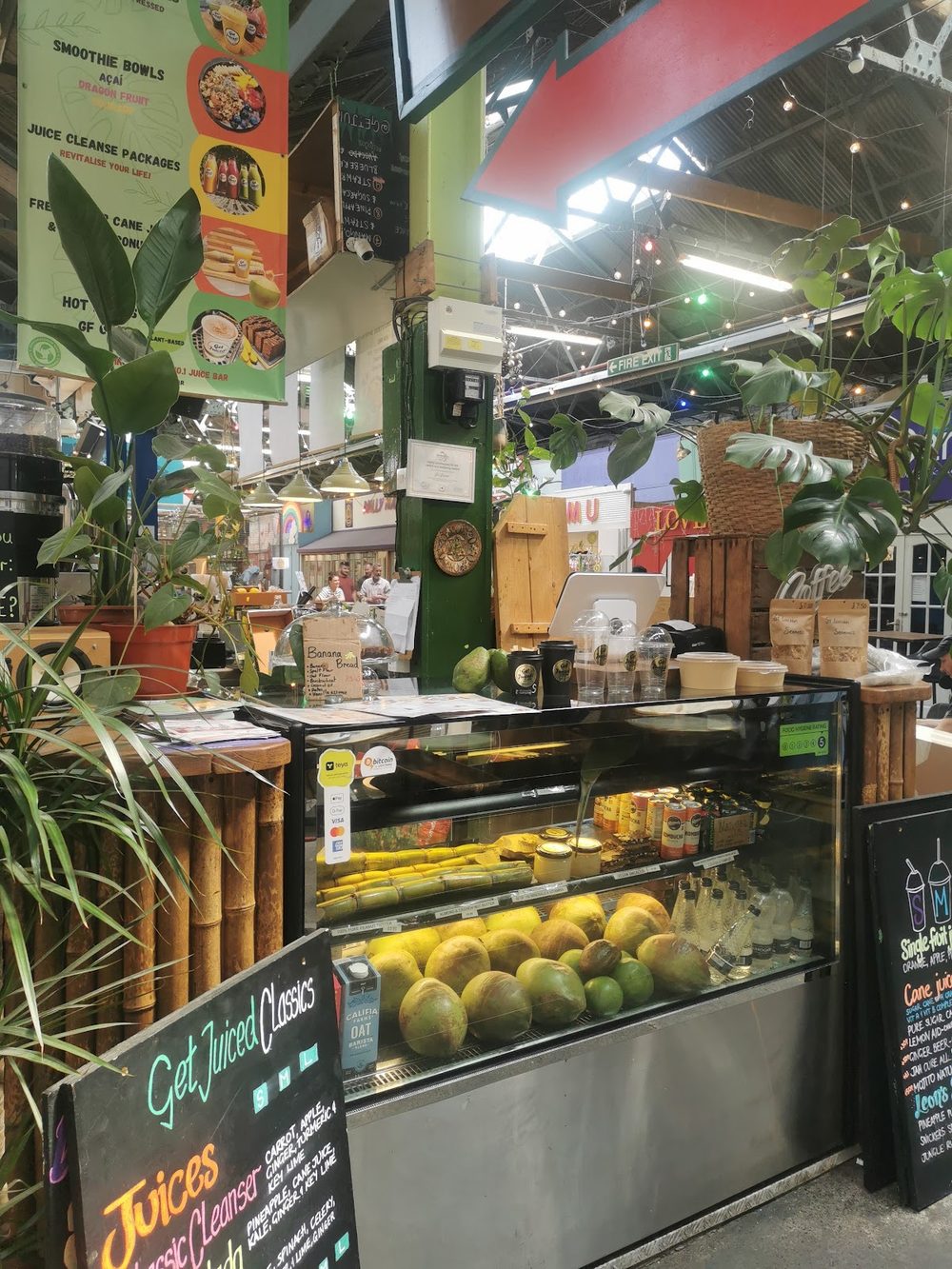 The bamboo-fronted juice stall piled with limes and greenery inside Tooting Market