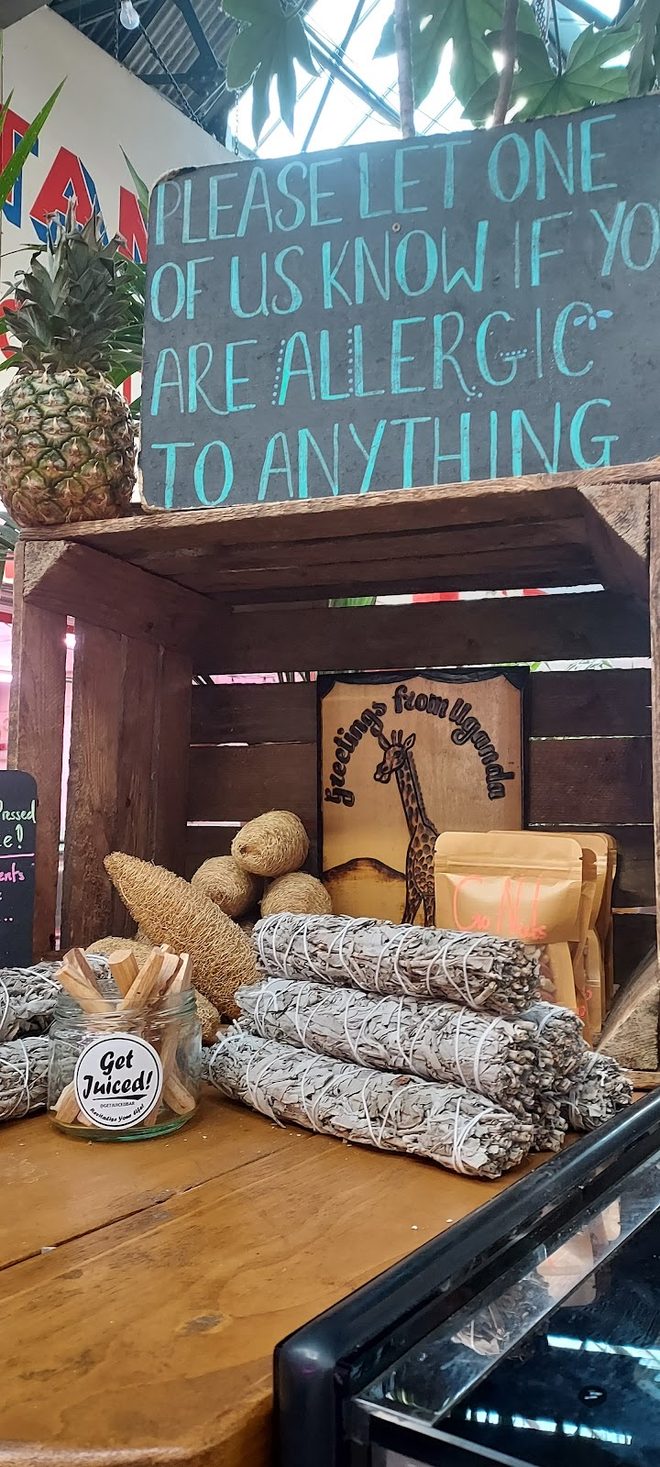 Corner shelf of pineapples and sugar cane