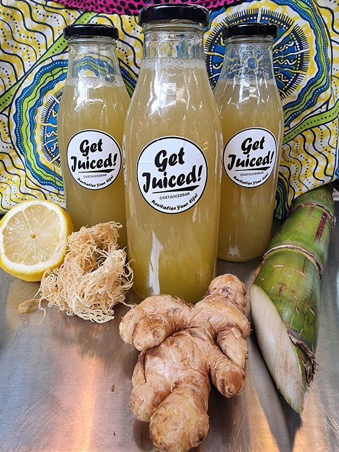 Bottled juices styled against a colourful African-print cloth